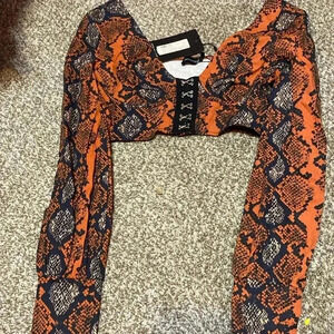 Pretty little thing burnt orange snakeskin plunge long sleeve